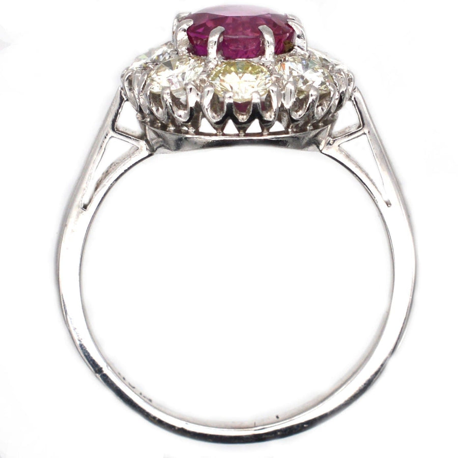 Mid 20th century platinum ring featuring 1.7 carat Burma ruby and diamond cluster, reflecting 1950s luxury style.
