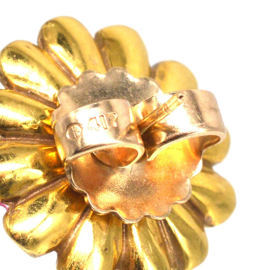 Close-up of a detachable gold flower petal jacket for mid century ruby and diamond cluster earrings.