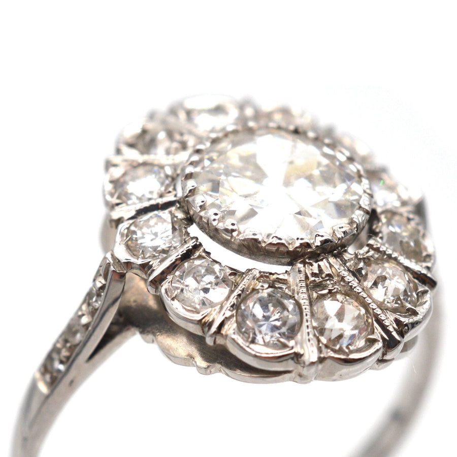 Mid Century 18ct white gold oval diamond cluster ring with a sparkling 1 carat center diamond.