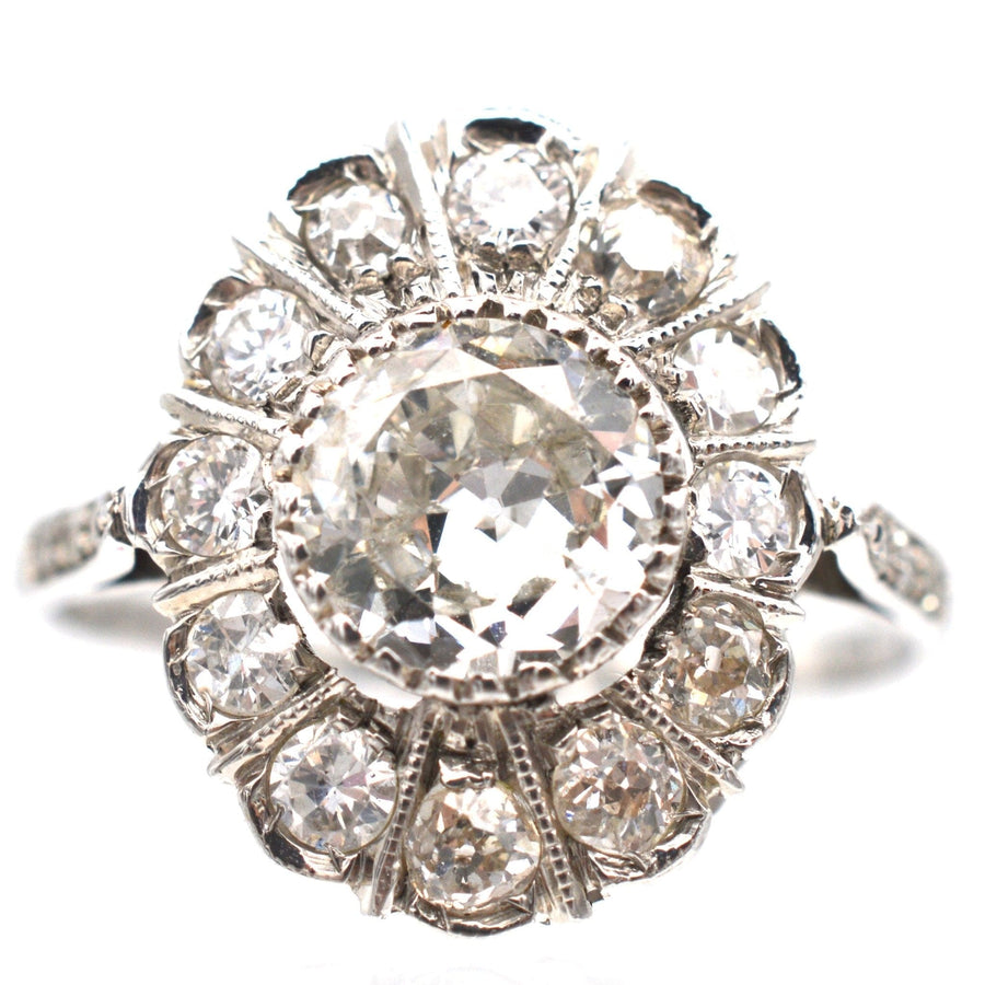 Mid Century 18ct white gold oval diamond cluster ring with 1 carat center diamond, circa 1960, elegant and sparkling design.