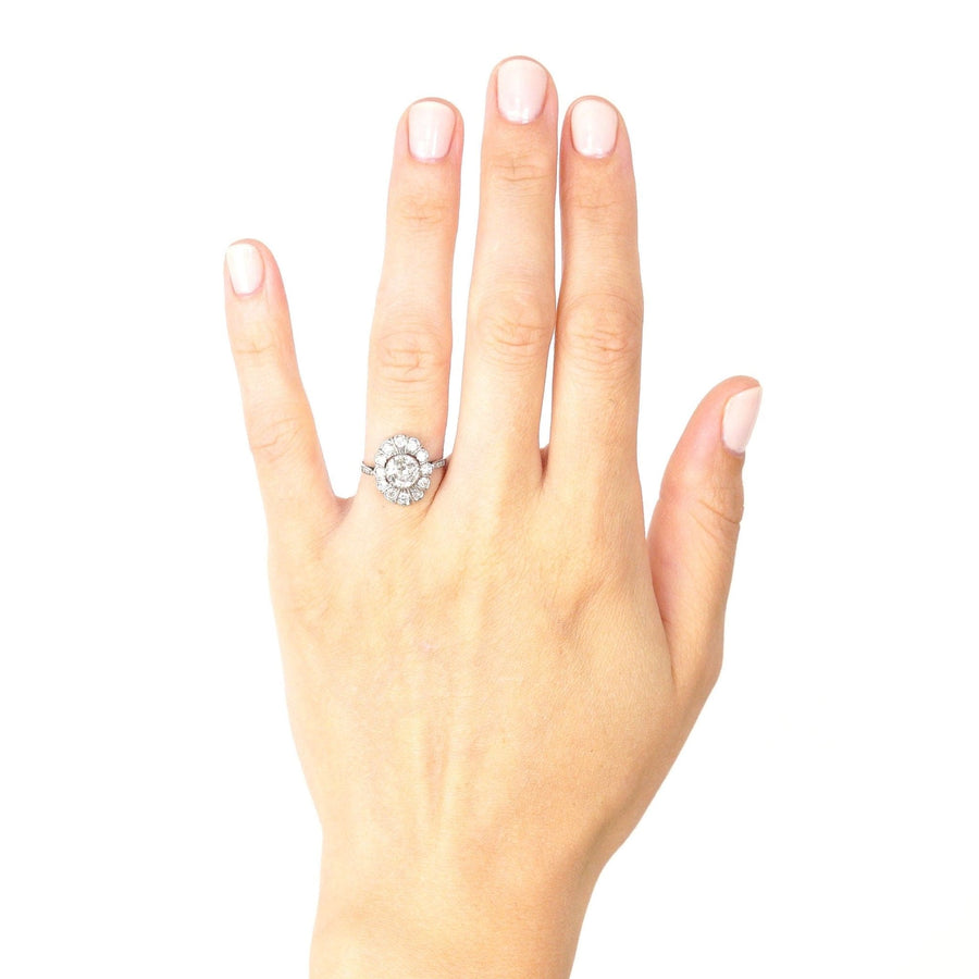 Mid Century 18ct white gold oval diamond cluster ring worn on a hand, showcasing its elegance and sparkle.