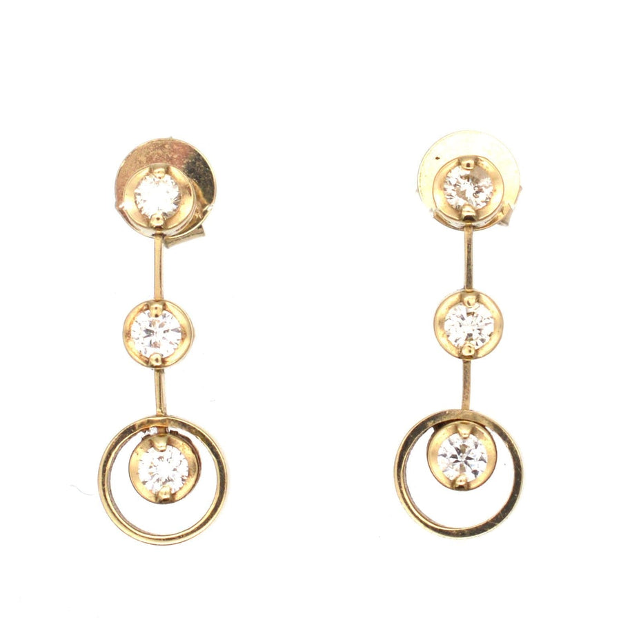 Modern 18ct gold three stone diamond drop earrings with sparkling bright white diamonds.