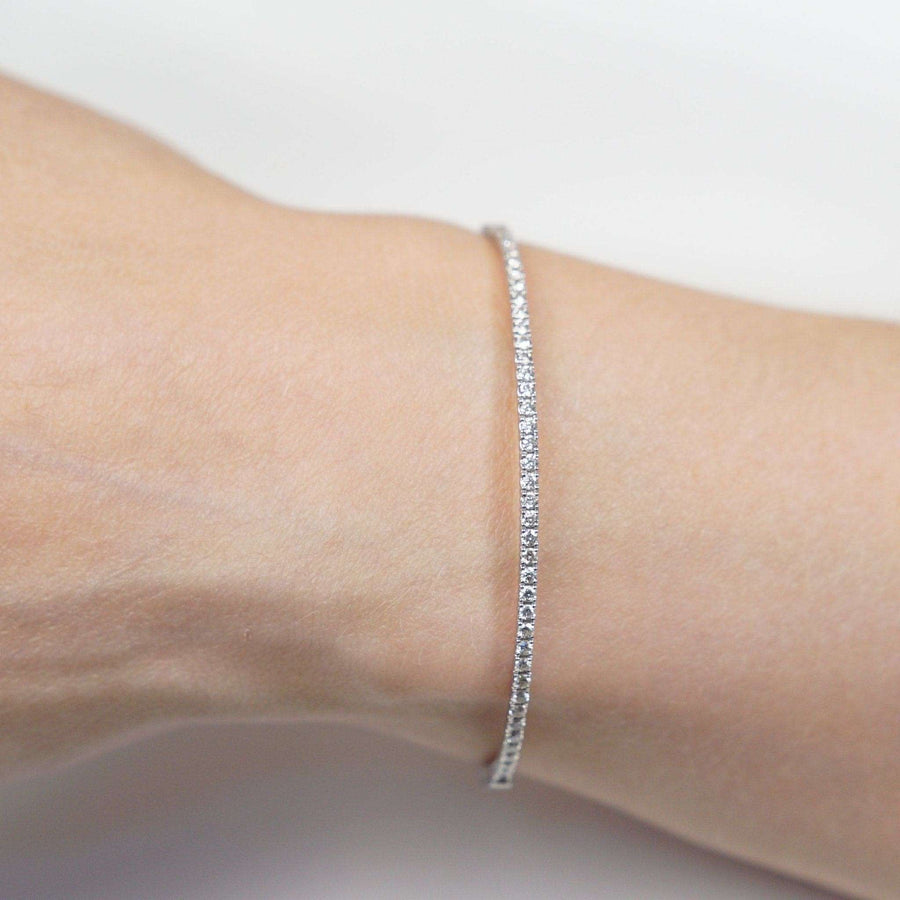 Elegant 18ct white gold diamond bangle on wrist, featuring 40 brilliant cut diamonds, perfect for stacking or gifting.