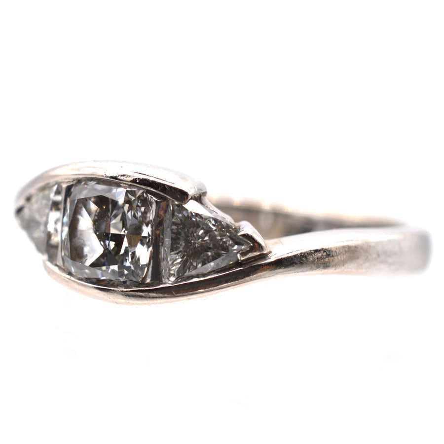 Modern 18ct white gold three stone diamond ring featuring GIA certified cushion cut diamond and trillion cut diamonds.