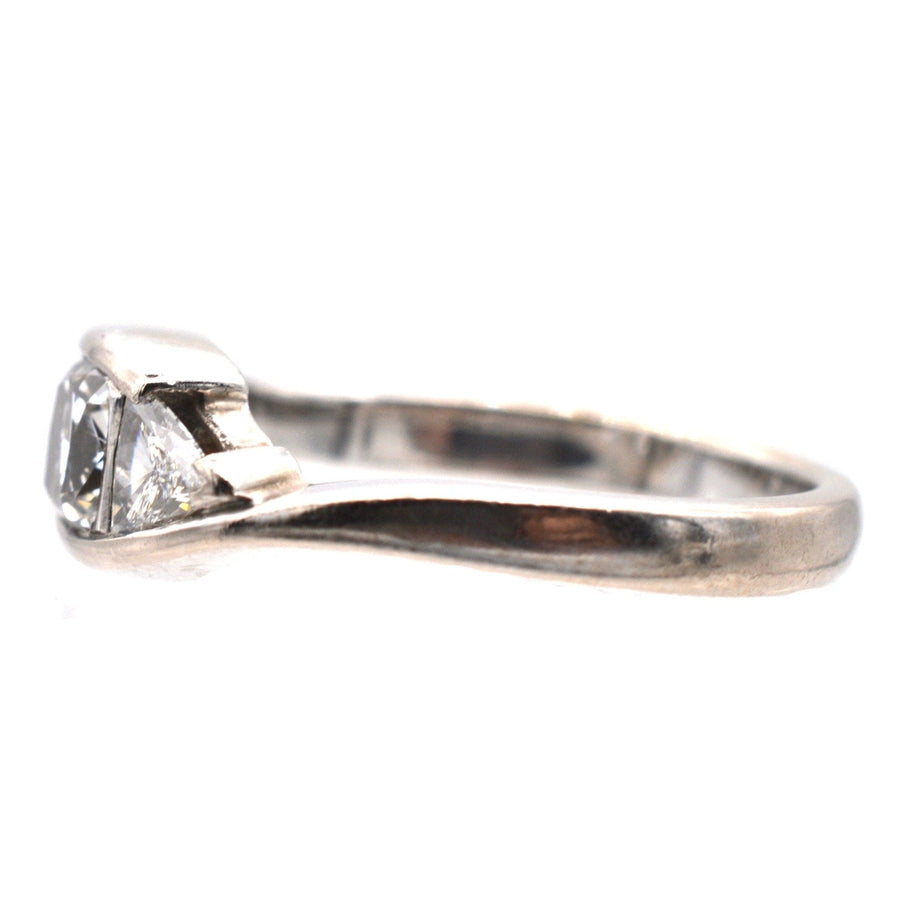 Modern 18ct white gold three stone diamond ring with GIA certified cushion cut diamond and trillion cut side stones.