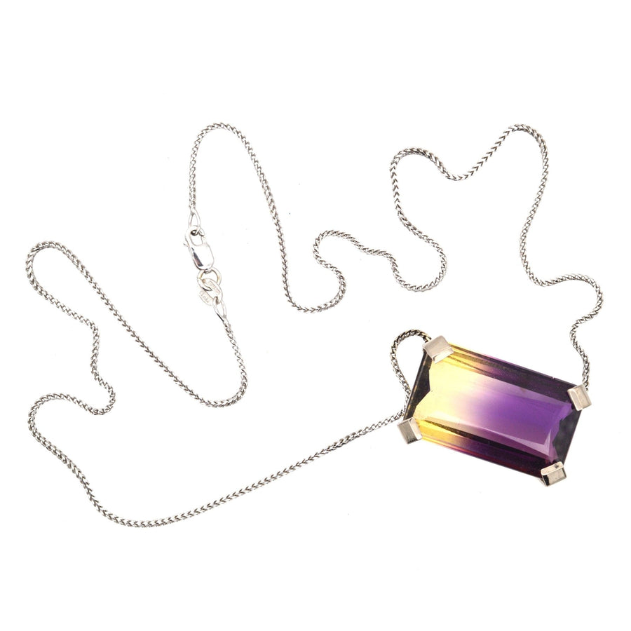 Modern 9ct white gold necklace featuring a 28 carat emerald-cut bi-colour ametrine gemstone.