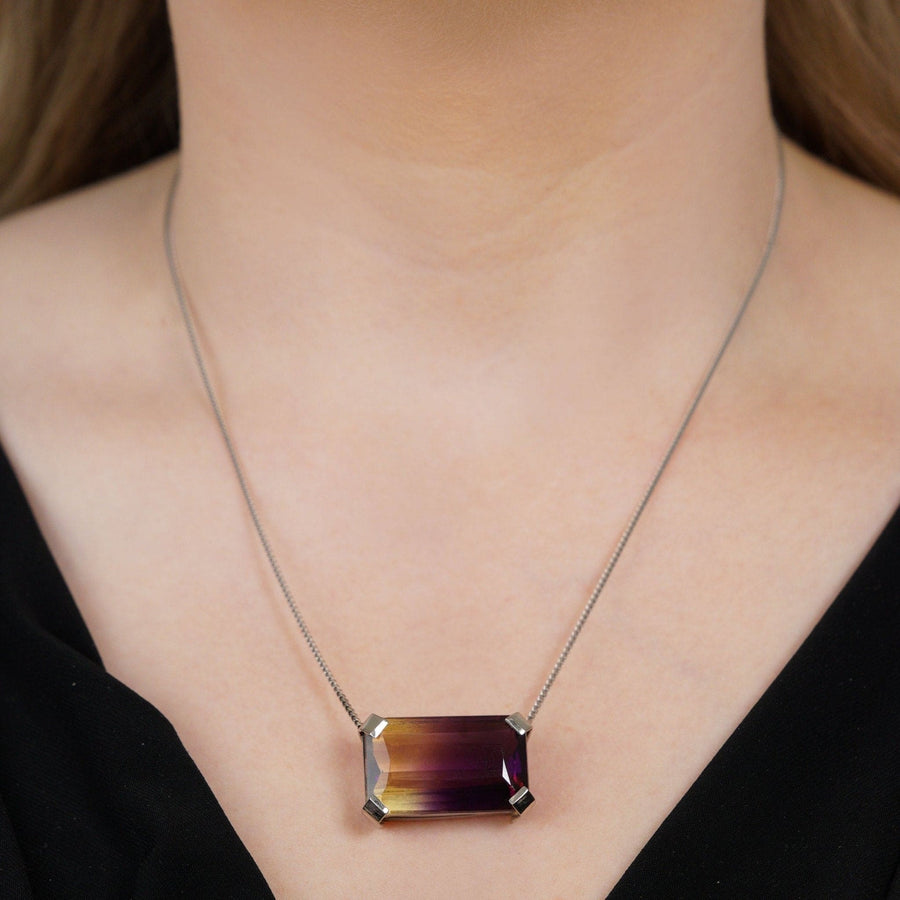 Modern 9ct white gold necklace featuring a 28 carat emerald-cut bi-colour ametrine pendant.