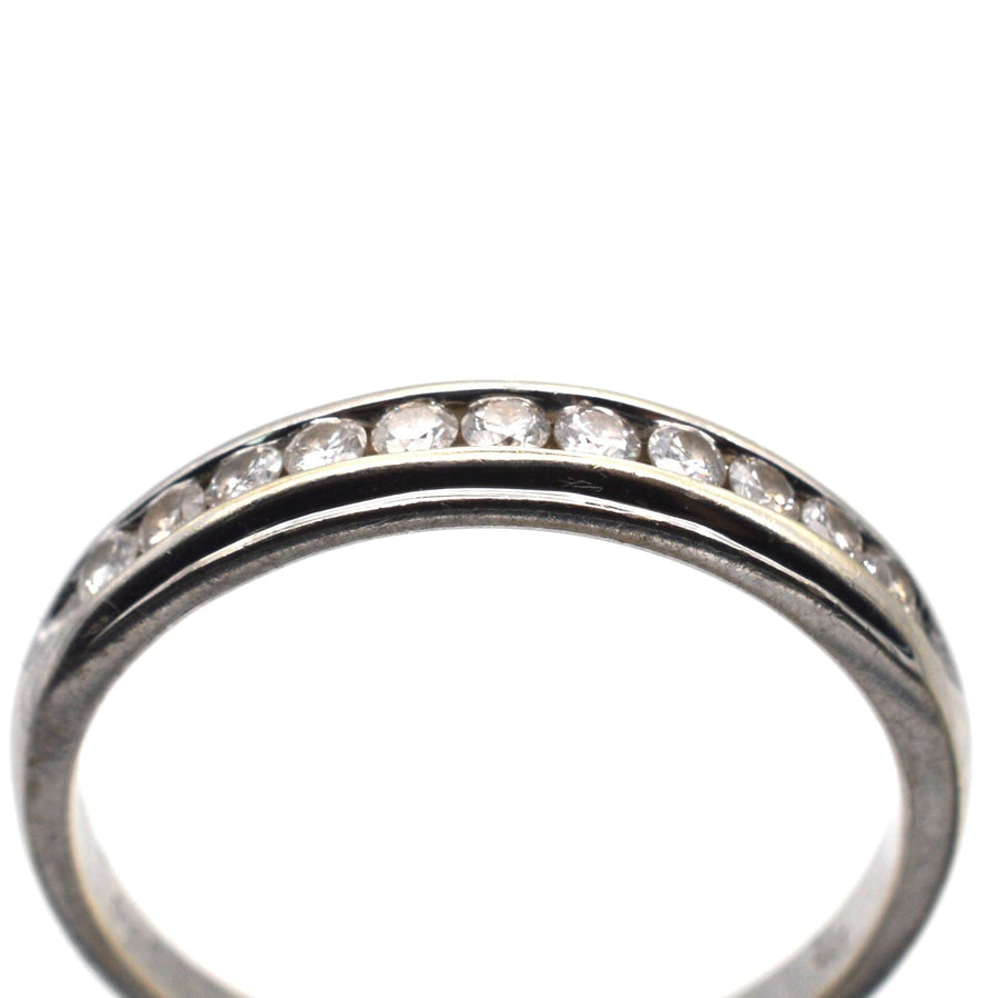 Modern 9ct white gold diamond half eternity ring with 0.25 carats of brilliant cut diamonds in channel setting.
