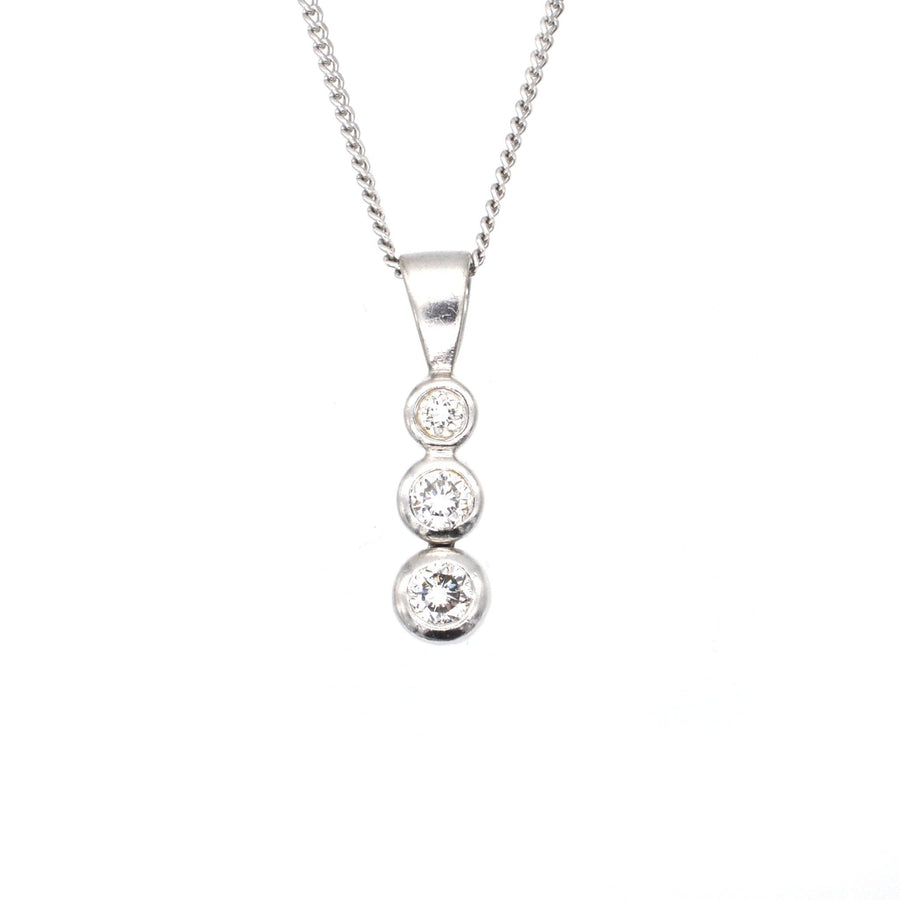 Modern platinum drop pendant featuring three white diamonds on a delicate platinum chain.