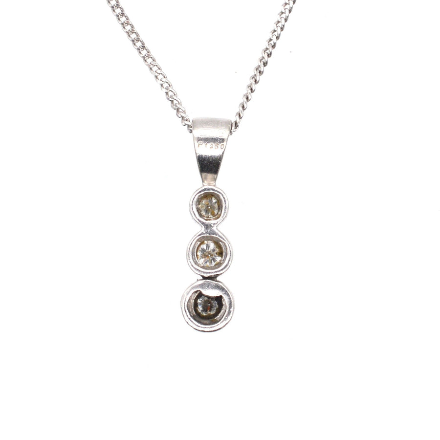 Modern platinum drop pendant with three bright diamonds on a sleek platinum chain, perfect for any occasion.