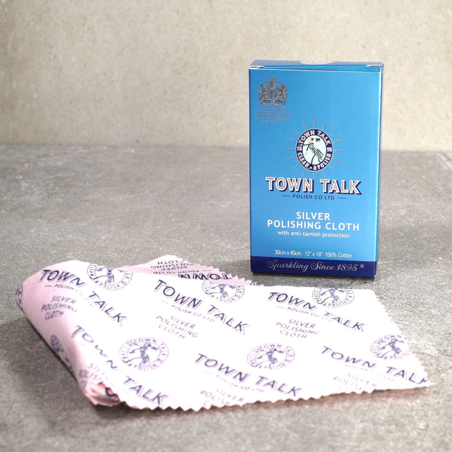 Town Talk Large Anti-Tarnish Silver Polishing Cloth packaging and cloth on a textured surface.