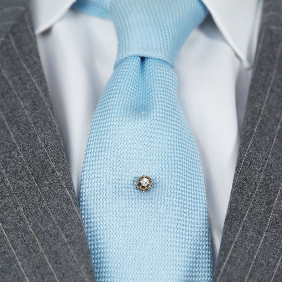 Victorian stickpin featuring a 0.20ct old mine cut diamond on a light blue tie, circa 1880.
