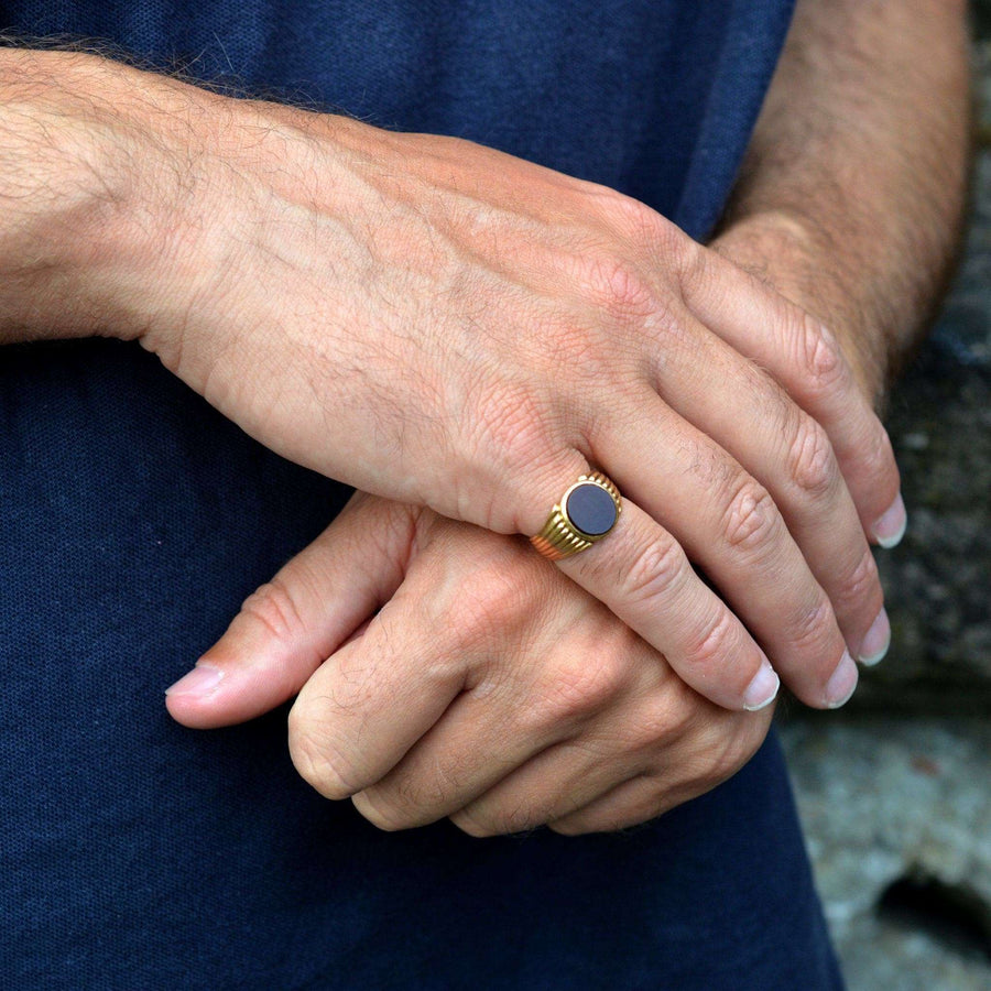 Victorian 18ct gold signet ring with carnelian stone worn on a man's hand, showcasing its elegant design.