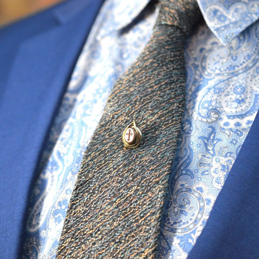 Victorian 9ct gold tie pin featuring carnelian intaglio cross on a patterned tie, stylish accessory for formal wear.