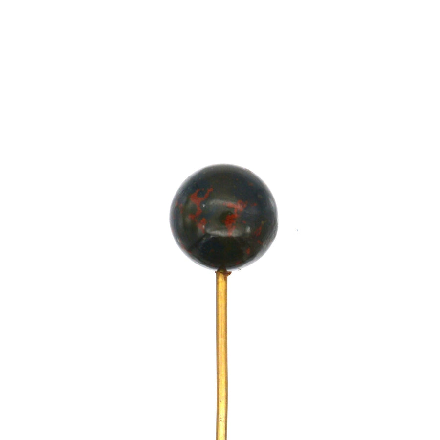 Victorian gold tie pin featuring a spherical bloodstone with red spots, symbolizing bravery and vitality.