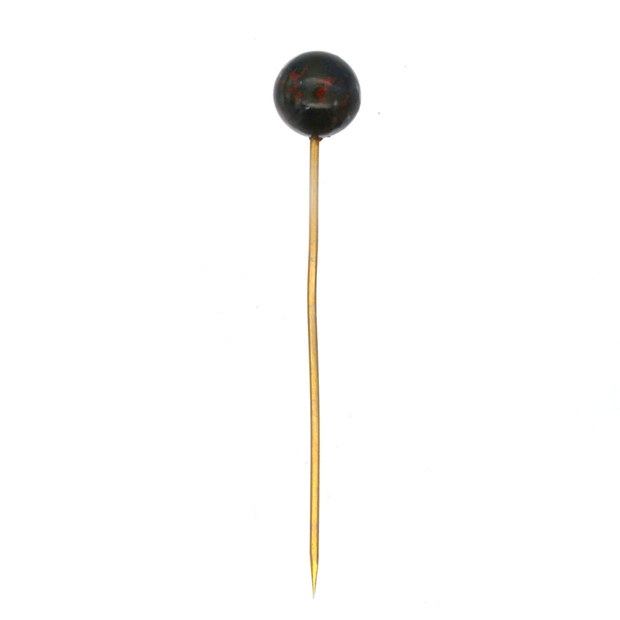 Victorian gold tie pin featuring a spherical bloodstone with red spots, symbolizing bravery and vitality.