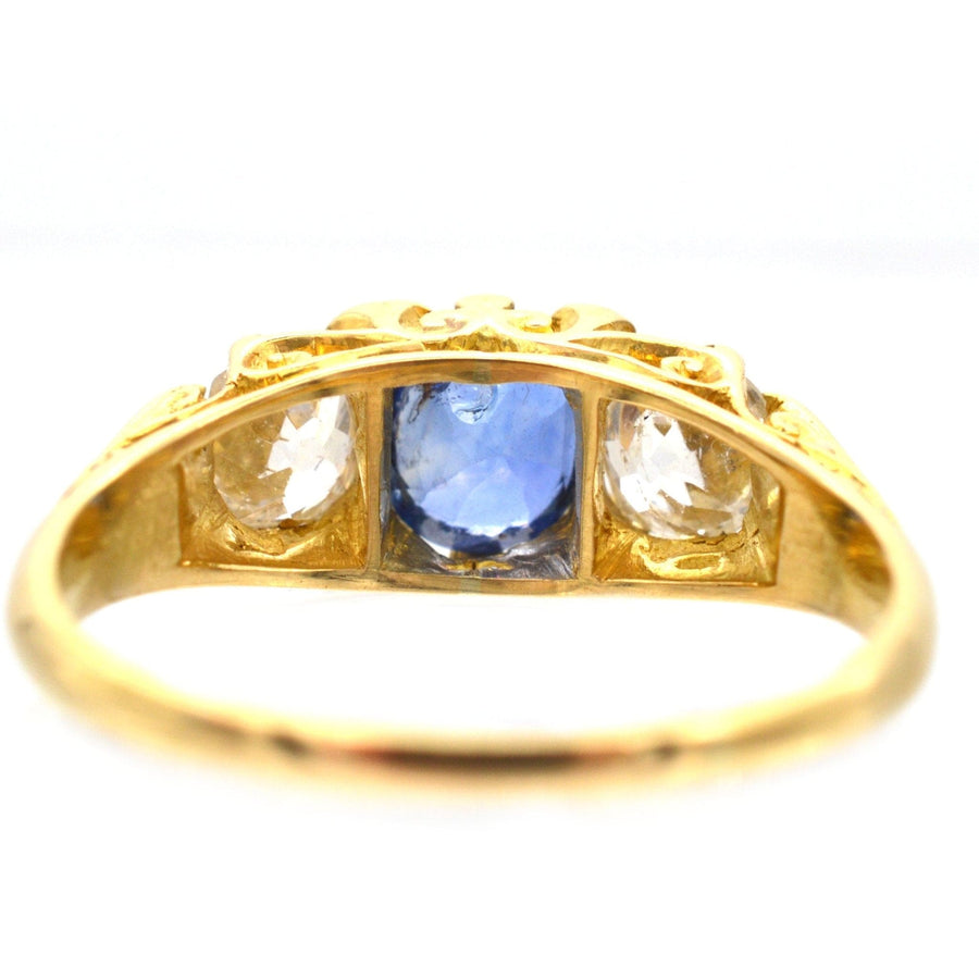 Victorian-style 1960s 18ct gold three stone sapphire and diamond ring with carved detailing.