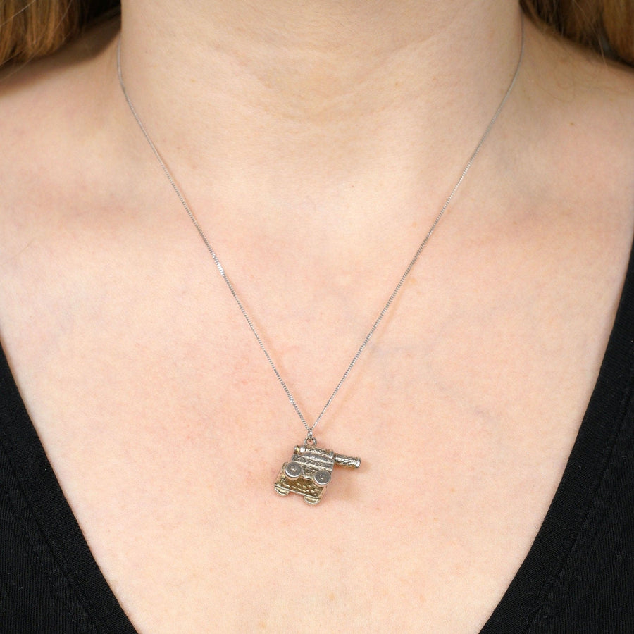 Vintage silver cannon pendant charm worn as a necklace, perfect for Arsenal fans and naval battle enthusiasts.