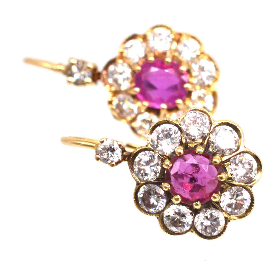 Edwardian 15ct gold diamond and ruby cluster earrings with hinged back setting for secure everyday wear.