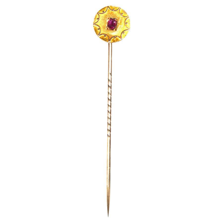 Victorian 15ct gold circle tie pin featuring a natural ruby, adorned with gold swirls, perfect for silk ties.