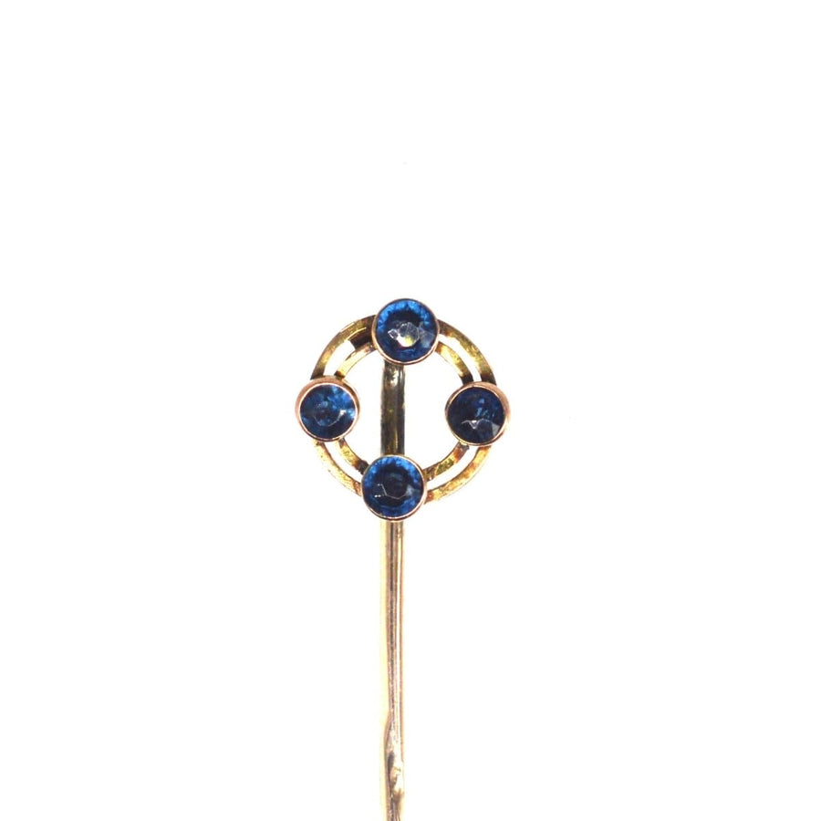 Art Deco 9ct gold circular tie pin featuring four vibrant sapphires, hallmarked Chester 1924.