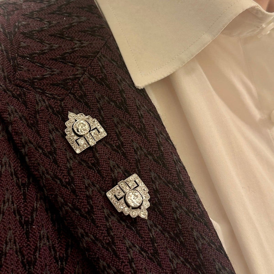 Art Deco platinum jabot brooch with old European cut diamonds displayed on a vintage jacket.