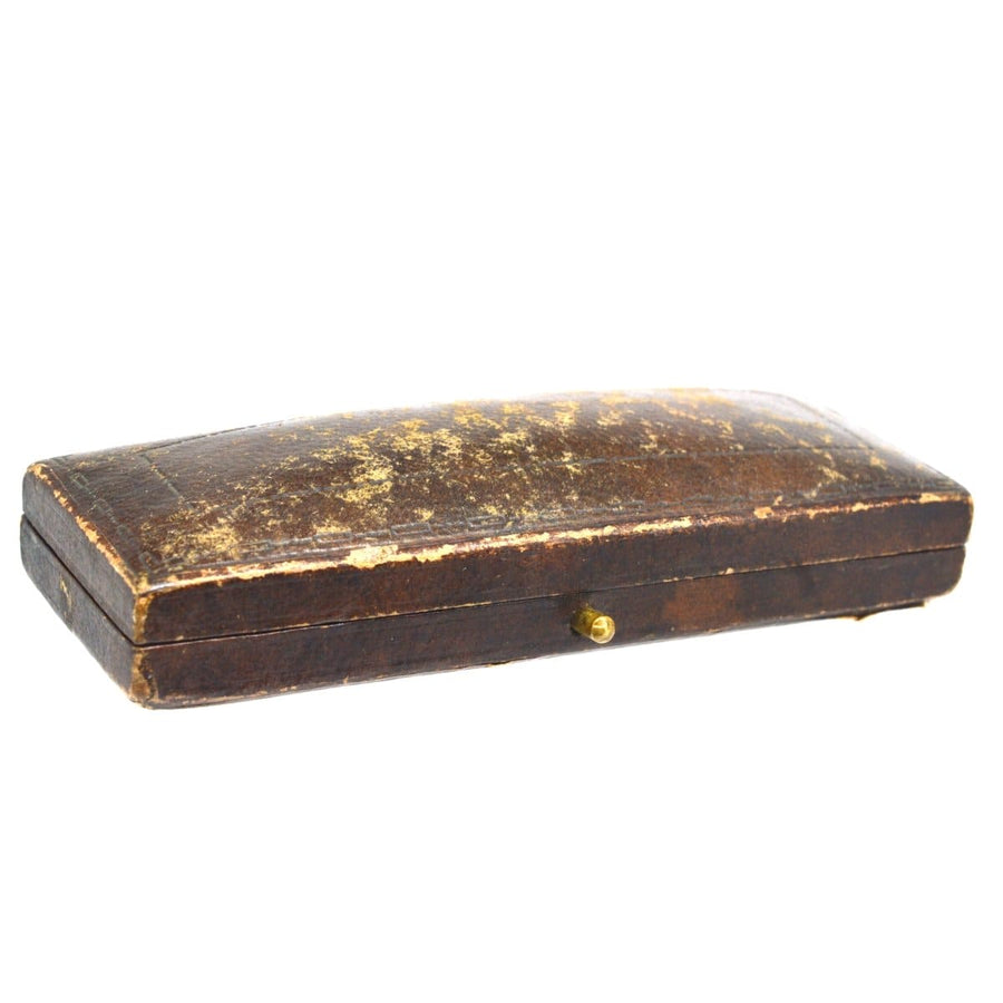 Antique brown leather case with worn surface and brass clasp, ideal for jewelry or accessories.