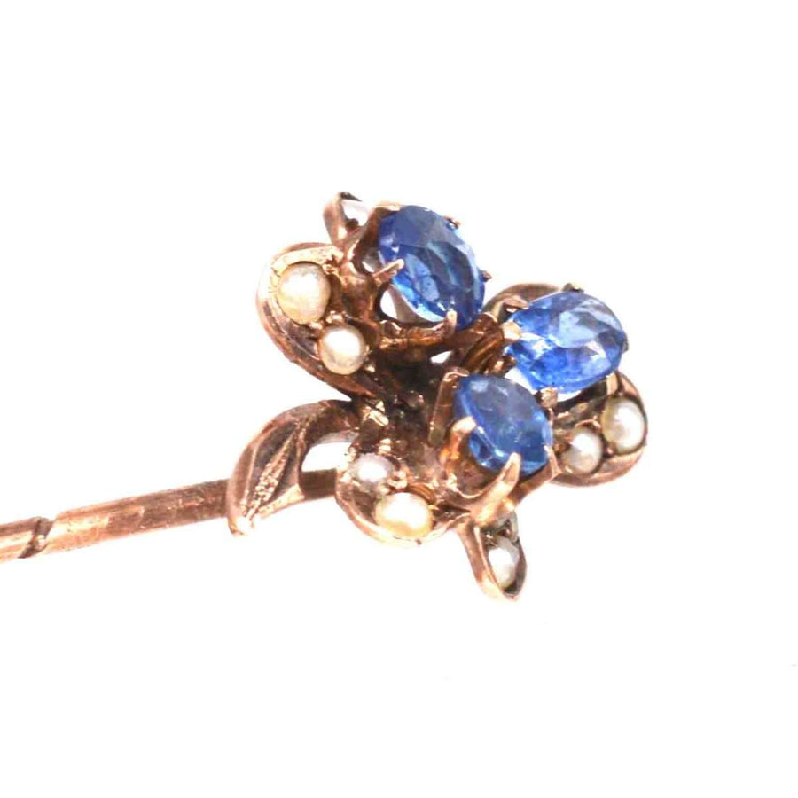 Early 20th century 8ct gold tie pin with blue sapphires and seed pearls in a clover design.