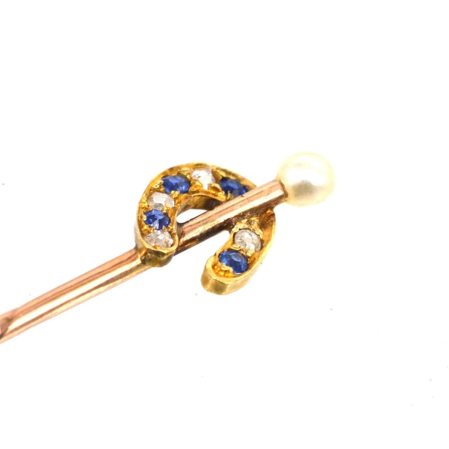 Edwardian 15ct gold horseshoe tie pin with sapphire, diamond, and a natural pearl on top.