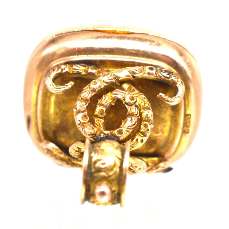 Edwardian 9ct gold locket pendant featuring embossed swirl design and bloodstone compartment, ideal for photos.