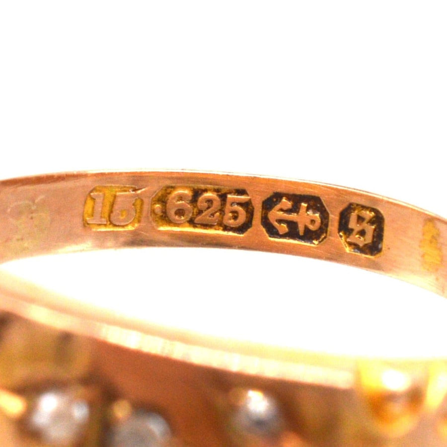 Close-up of the hallmark and karat markings inside a vintage Victorian gold band ring with rose cut diamonds.