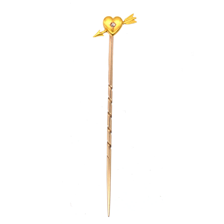Edwardian 15ct gold heart and arrow tie pin with rose diamond, symbolizing romantic love.