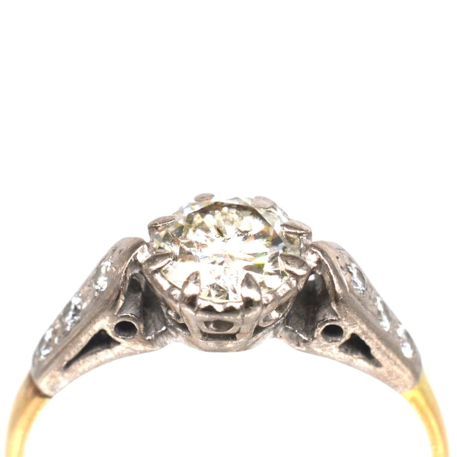 Solitärring aus 18-karätigem Gold und Platin mit Diamanten auf den Schultern und einem großen zentralen Diamanten.