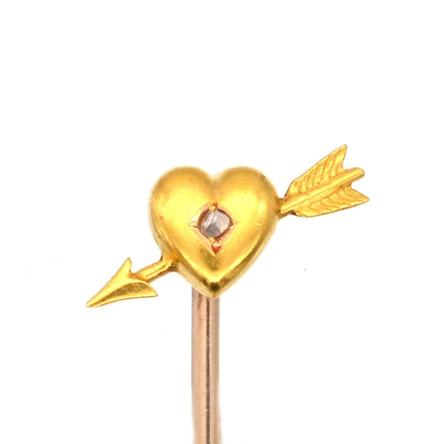Edwardian 15ct gold heart and arrow tie pin featuring a rose cut diamond, dating from the early 1900s.