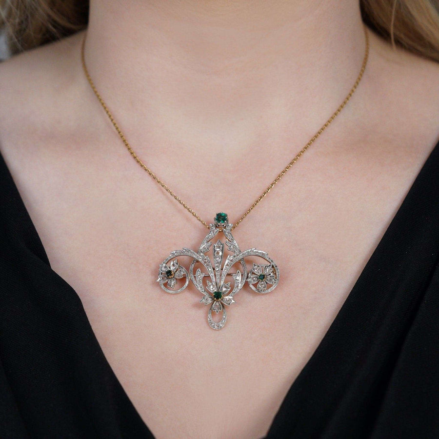 Edwardian 15ct gold and platinum emerald rose diamond brooch pendant worn on a model's neck.