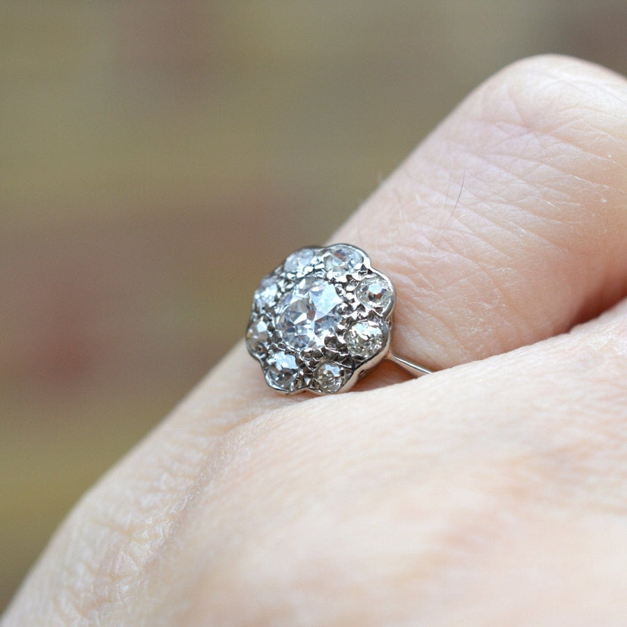 Edwardian 18ct white gold diamond cluster ring featuring a 0.40ct central stone and eight surrounding diamonds.