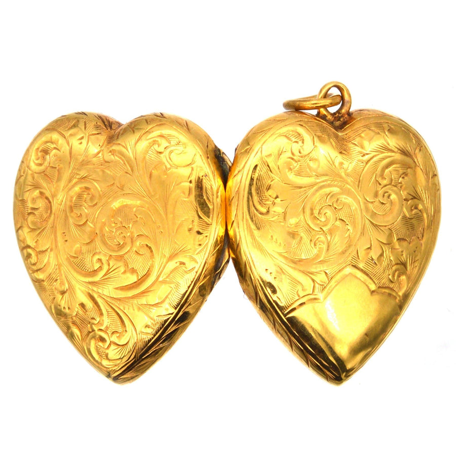 Edwardian 9ct gold heart locket pendant with engraved scroll motifs front and back, dating from 1900-1910.