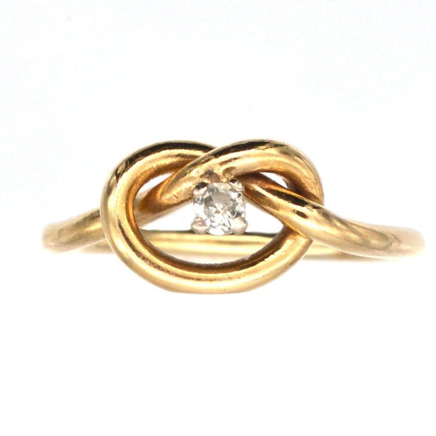 Elegant 9ct gold lover's knot ring featuring a central diamond, symbolizing infinite love and connection.