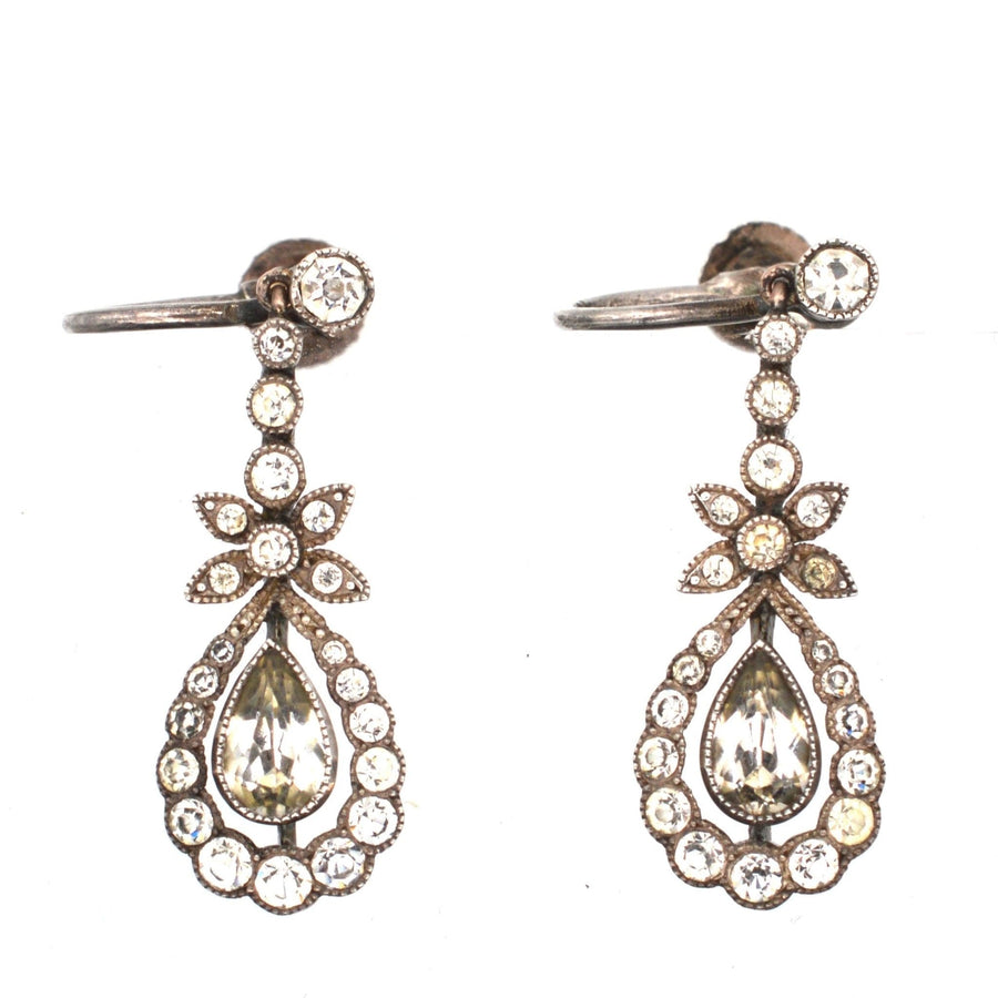 Mid-century silver and paste drop earrings featuring elegant flower and teardrop designs with sparkling details.