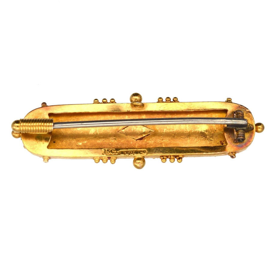 Victorian 15ct gold Etruscan revival bar brooch, 1870s, featuring intricate decorative design.