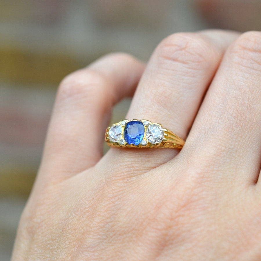 Ring aus 18 Karat Gold im viktorianischen Stil mit einem kornblumenblauen Saphir und zwei Diamanten im Altminenschliff.