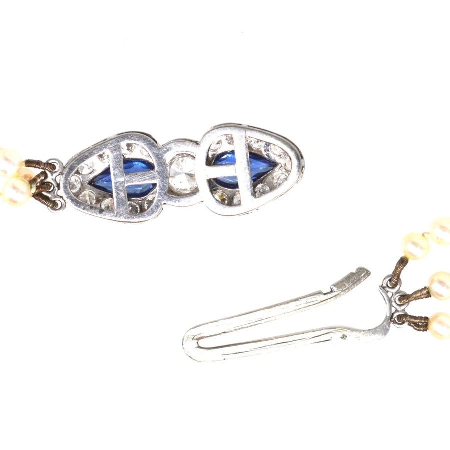 1940s cultured pearl triple strand necklace with sapphire and diamond clasp, featuring royal blue sapphires.