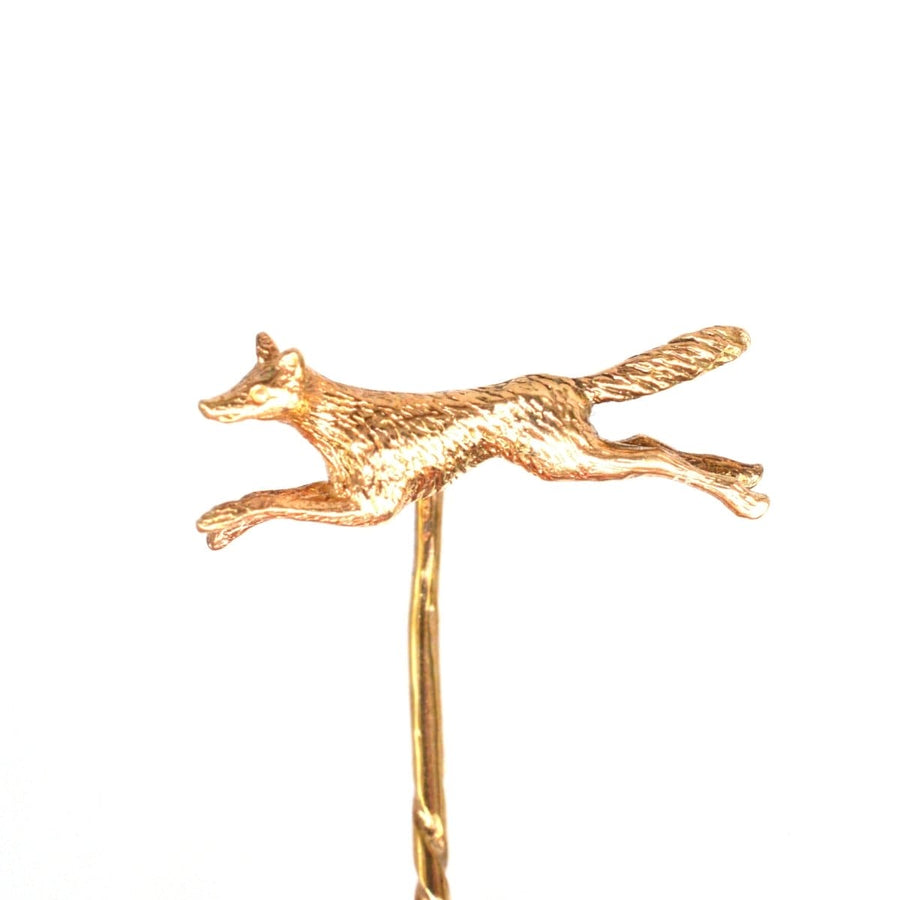 1950s 9ct gold running fox tie pin, showcasing a fox in motion, hallmarked for 1954, with included stoppers.
