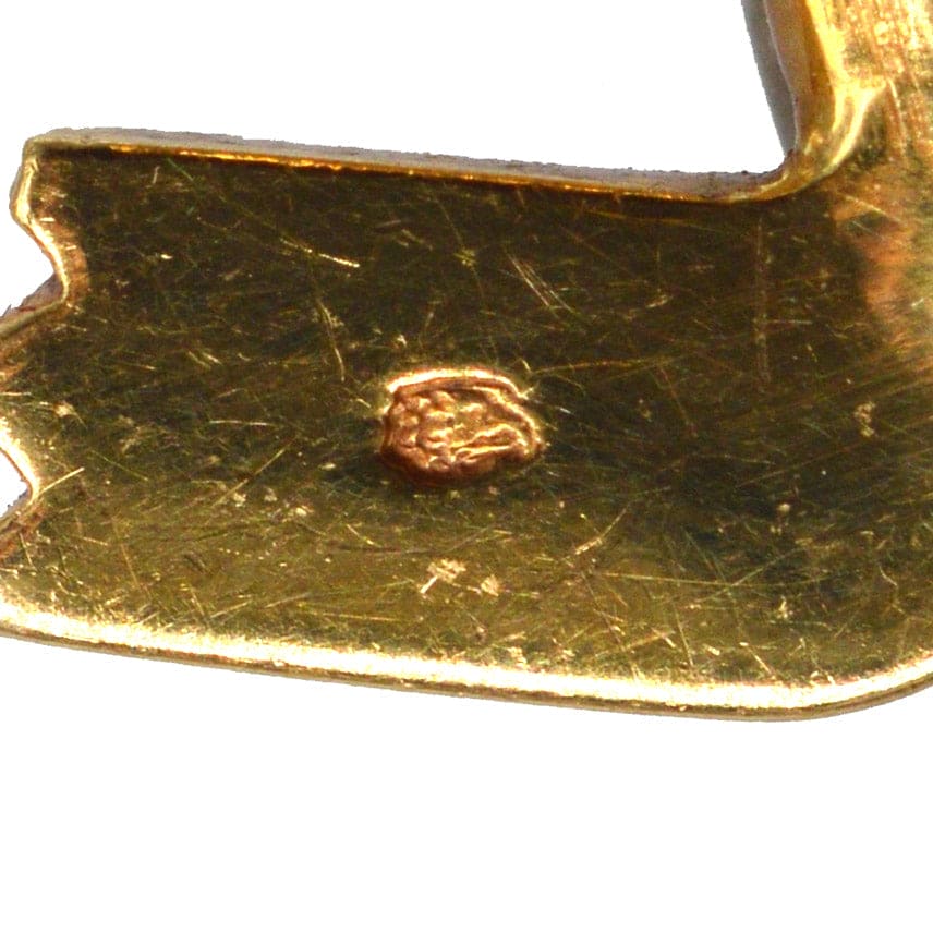 Close-up of the clasp on a vintage Cartier 18ct gold brooch, showing detailed stamp and craftsmanship.