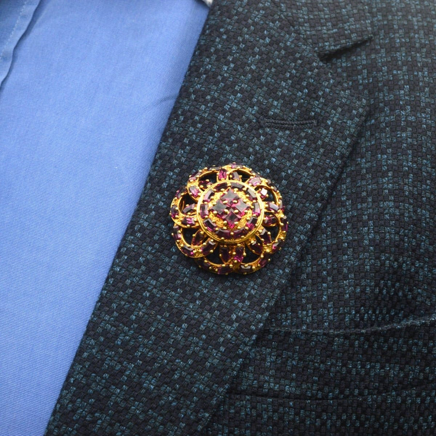 19th century French gold brooch featuring rhodolite garnets, worn on a blazer lapel.