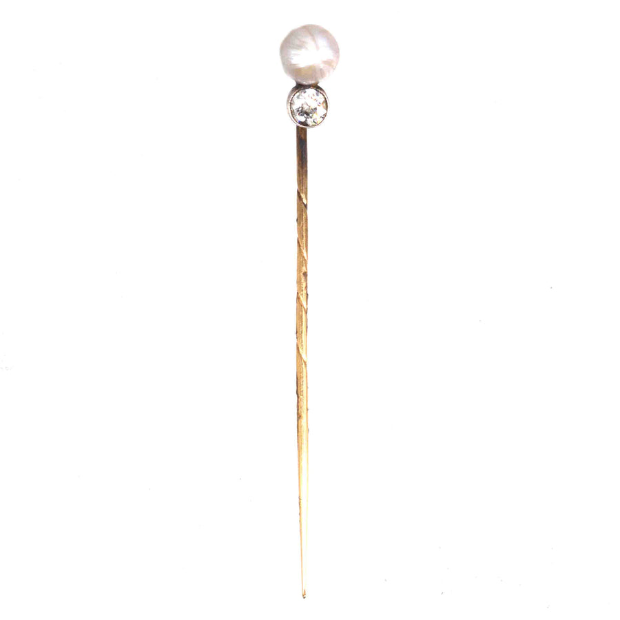 Edwardian 15ct gold tie pin with natural pearl and diamond, symbolizing elegance and sophistication.