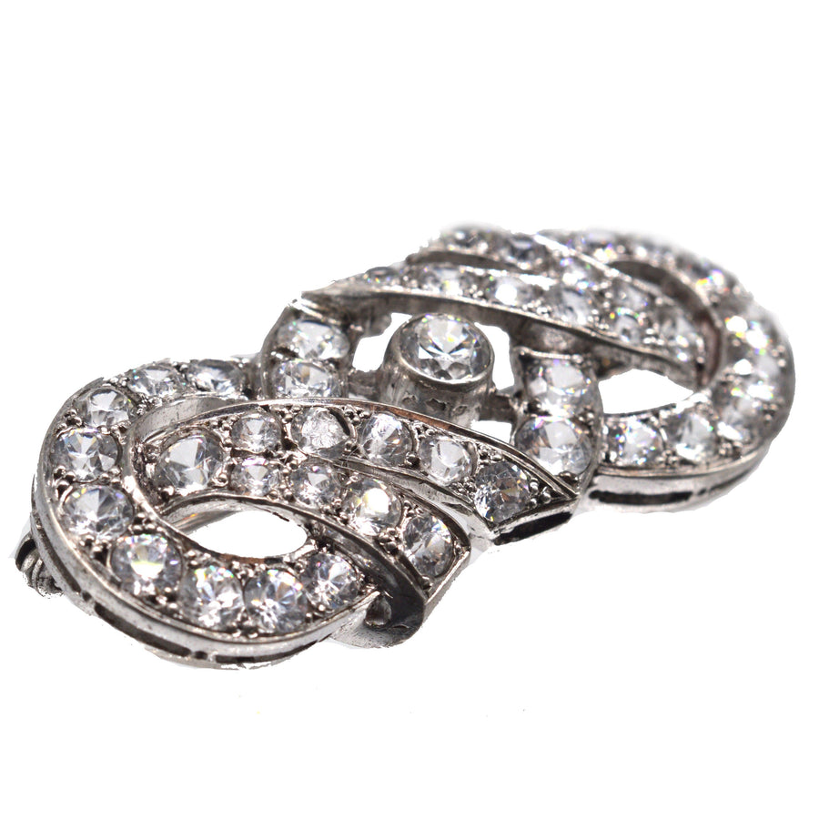 French Art Deco silver paste brooch featuring intricate geometric design and sparkling stones, dating back to the 1930s-1940s.