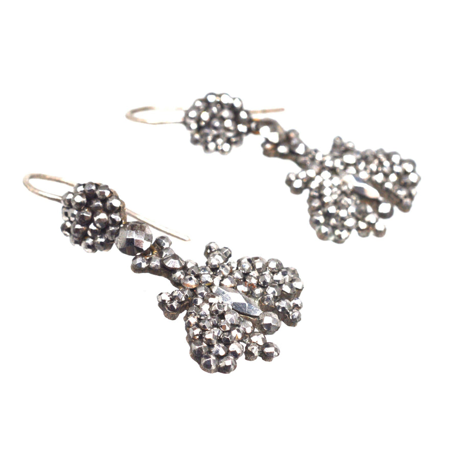Early 19th Century cut steel butterfly earrings, featuring intricate steel studs for a sparkling, candlelit effect.