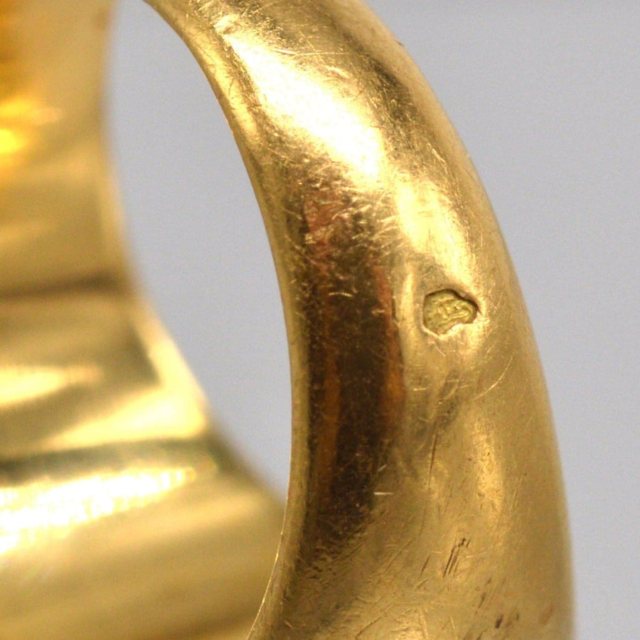 Close-up of the smooth band of an antique French 18ct gold signet ring, showcasing its buttery gold finish.