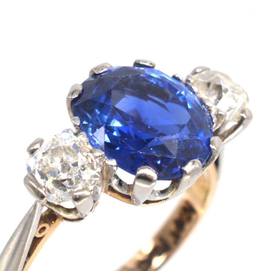 Art Deco 18ct gold and platinum three stone ring featuring a Ceylon sapphire and diamonds.